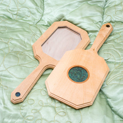 A beautiful Hand Mirror inspired by the Art Deco movement, in Maple with cherry and copper detail.