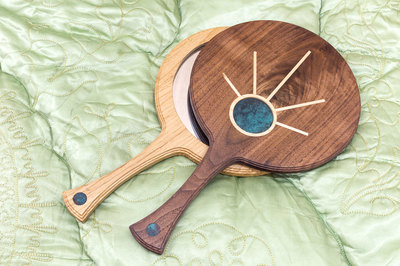 A beautiful Hand Mirror inspired by the Art Deco movement, in  Black walnut with maple and copper detail.